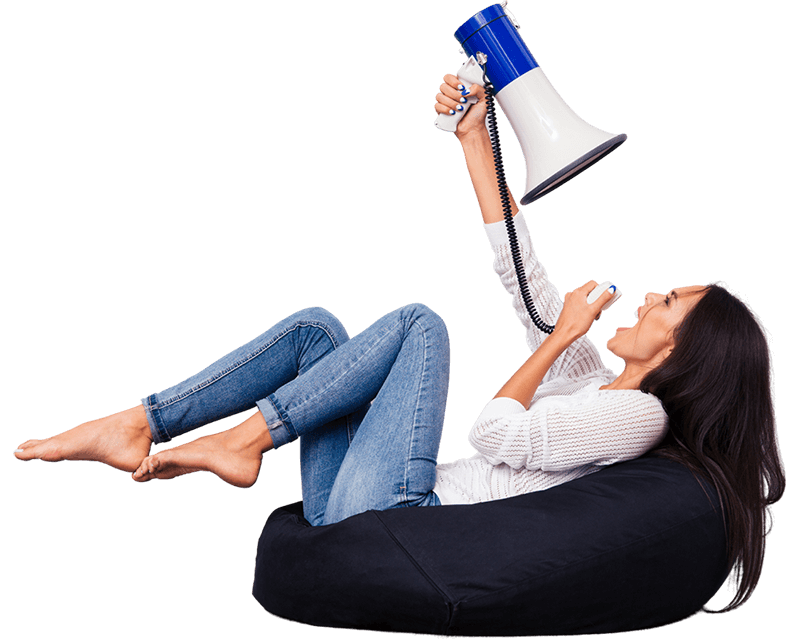 Woman sitting on bean bag chair and screaming in megaphone at herself